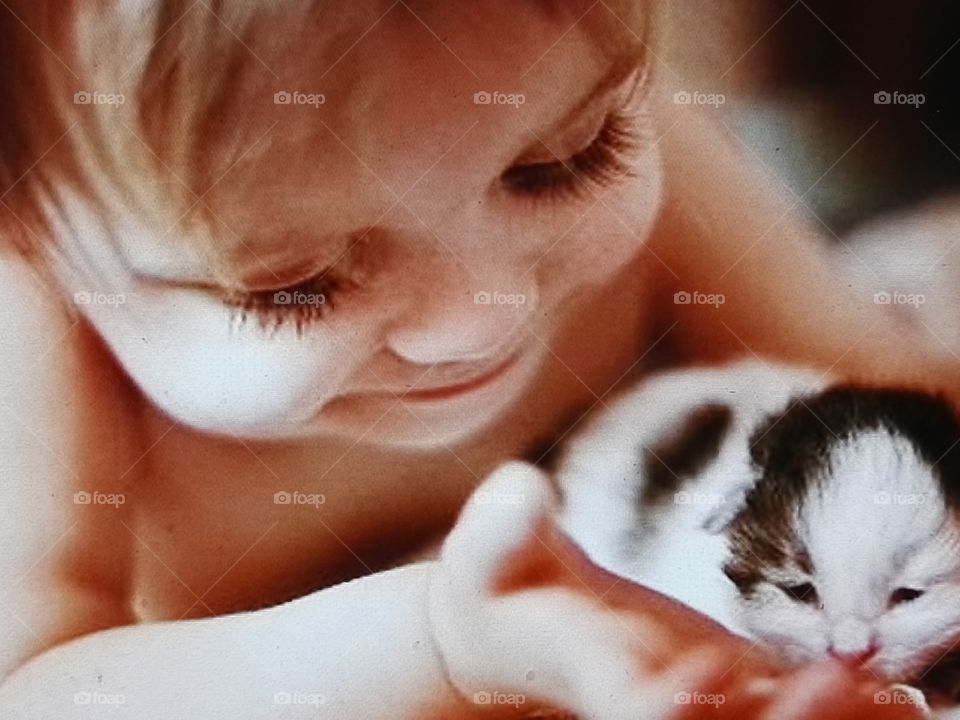 Cute baby playing with cat