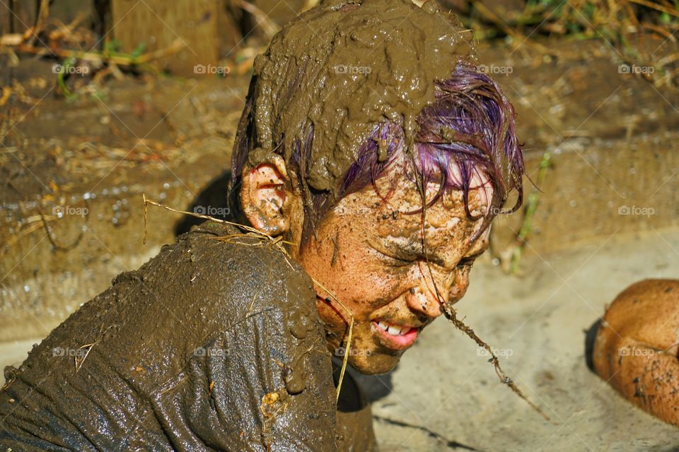 Boy Playing In A Mud Puddle