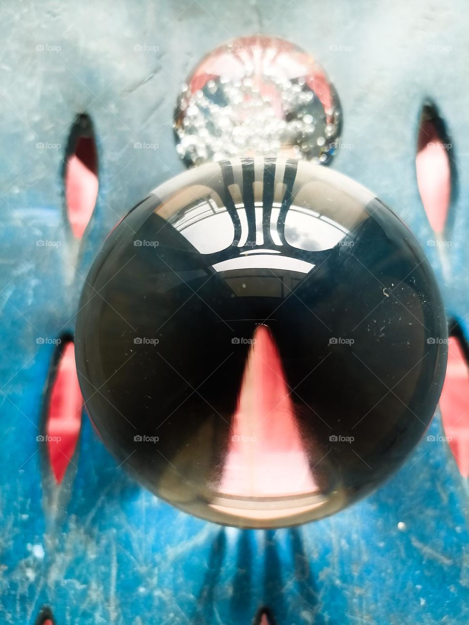 The sun shines through the holes in the chair. But the shadow of the crystal ball looked beautiful.