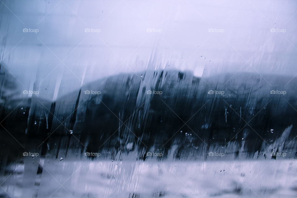 Raindrops and foggy glass window