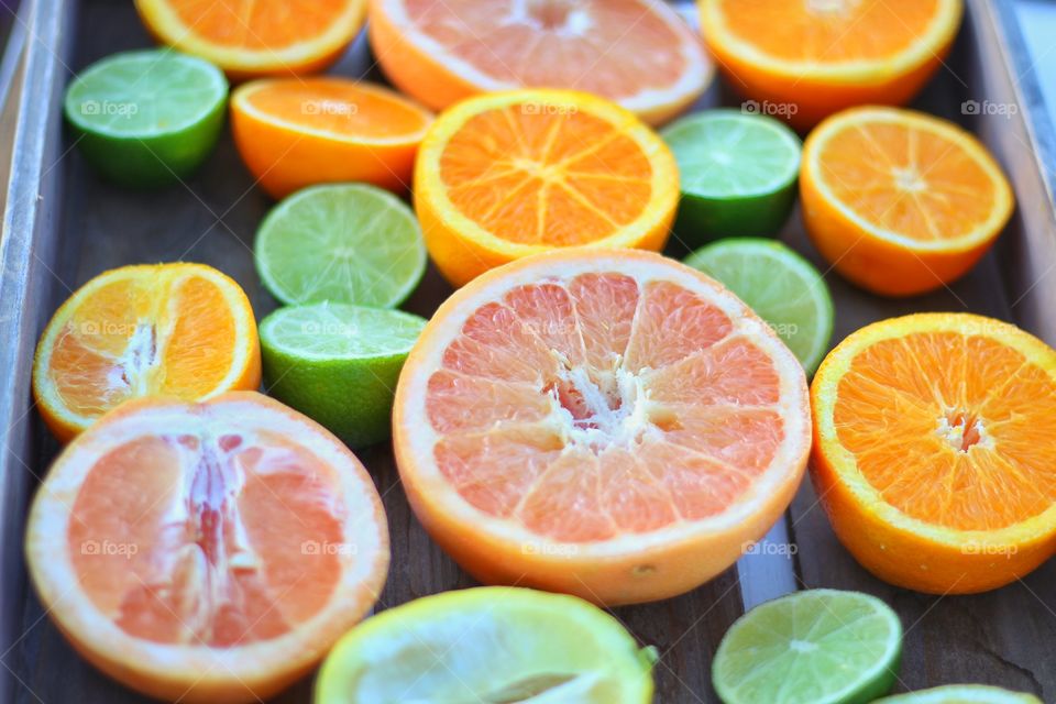 Halves of different citrus fruits