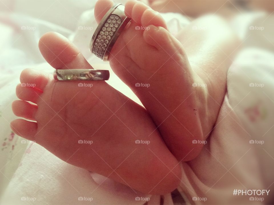 newborn feet. wedding rings. family.