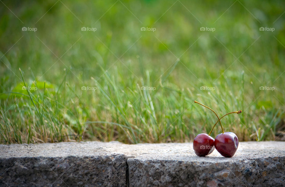 two cherries on rock