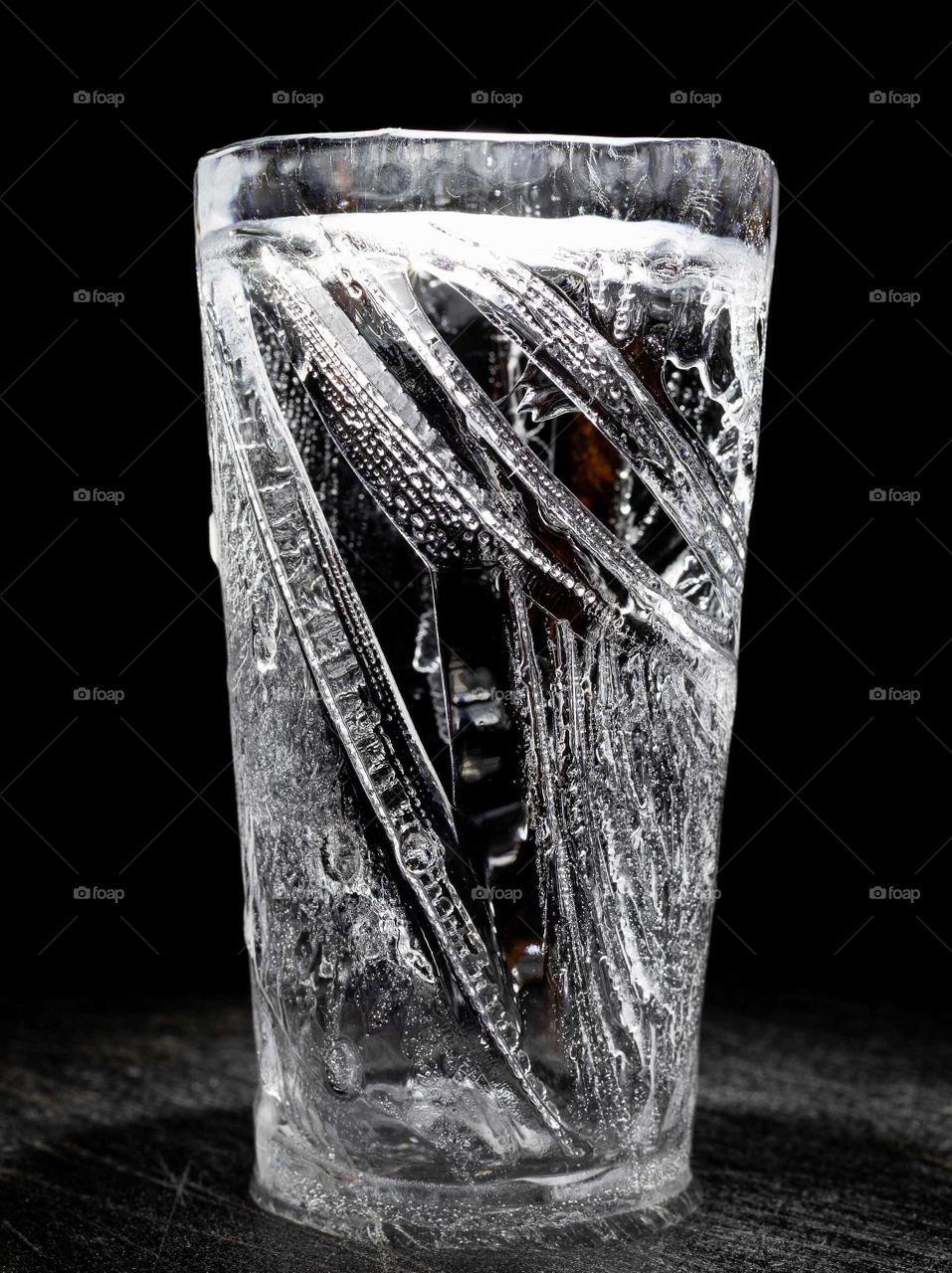 Give Me Light - I was experimenting with capturing air bubbles trapped in ice. I filled up an insulated cup with water and took it out believing it was solid. It wasn't and the remaining water drained and left this hollowed out ice behind.