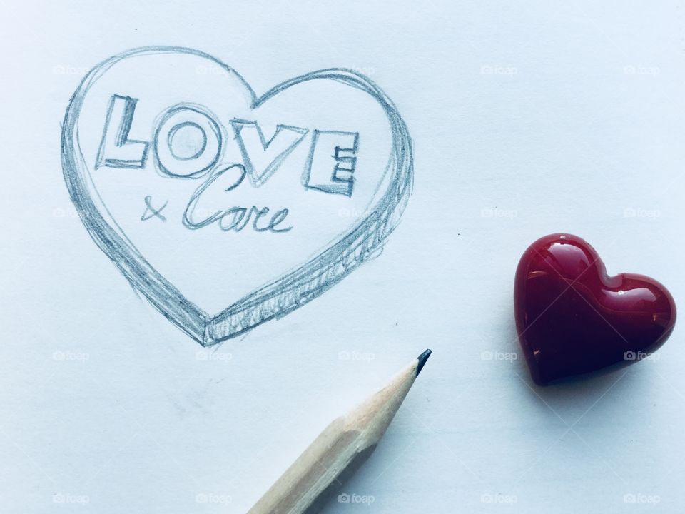 Hand drawn heart, love & care. With pencil and a glass heart.