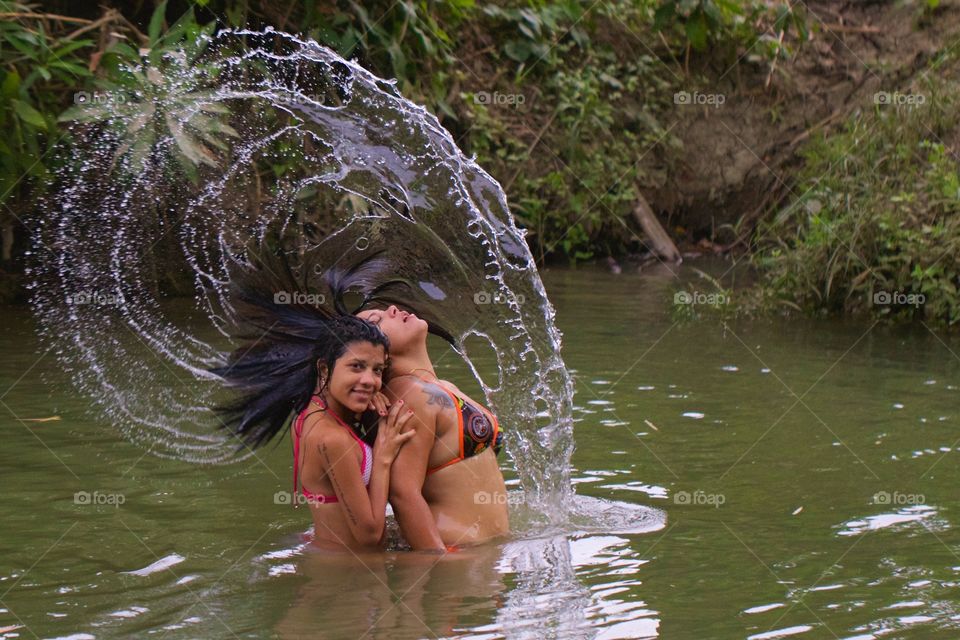 Girls Splashing The Water With Their Hair