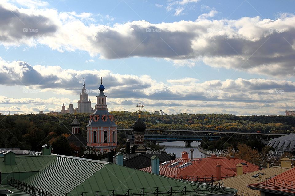 Observatian deck view near Russian Academy of Sciences over the colorful rooftops, orthodox church, Moscow State University, Moscow river and autumn park
