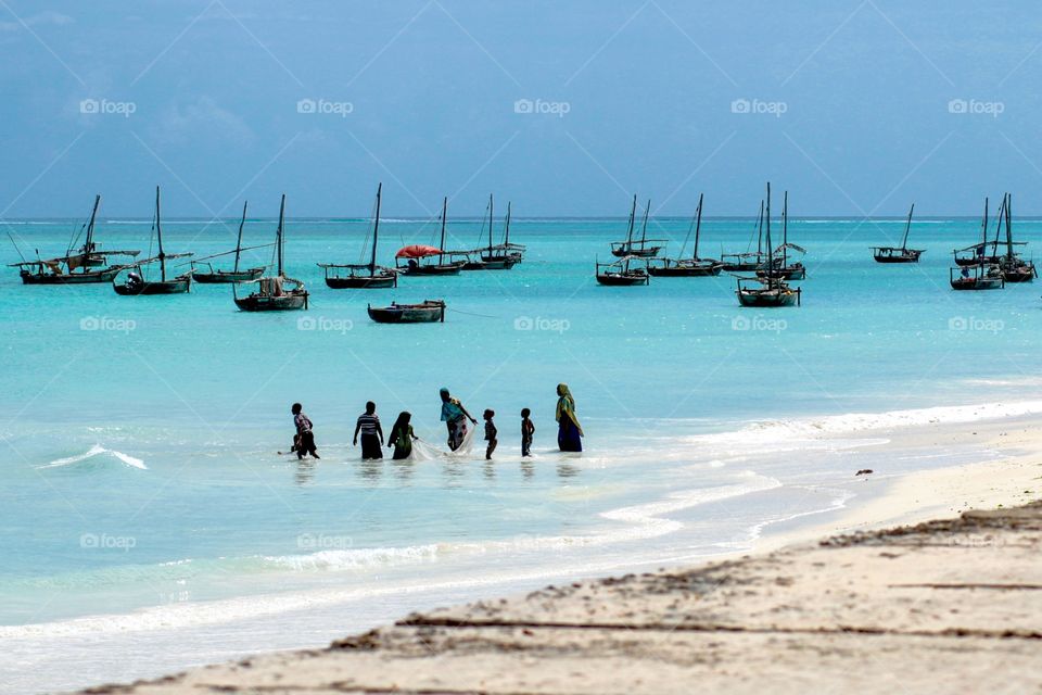 Nungwi Beach Zanzibar Island. Cast-net fishing family