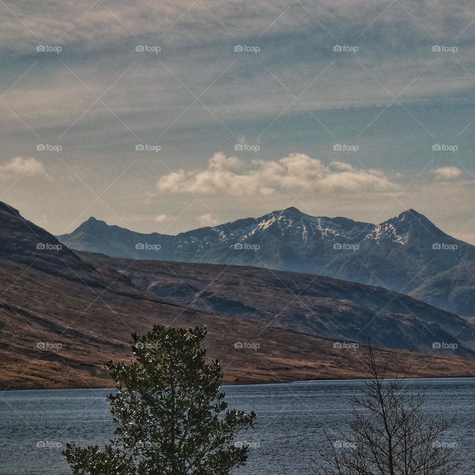 Mountains, loch, trees, cloudy sky