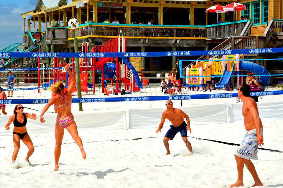 A couples team plays sand beach volley ball by the Gulf of Mexico! There was plenty of action as seen in the photo!