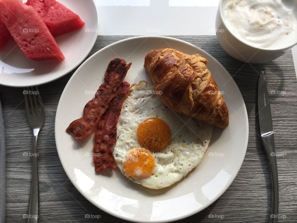 Breakfast - Eggs, Bacon, Croissant, Watermelon, Cappuccino 