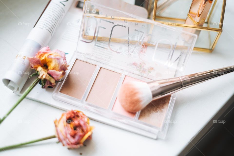 Makeup products on window sill