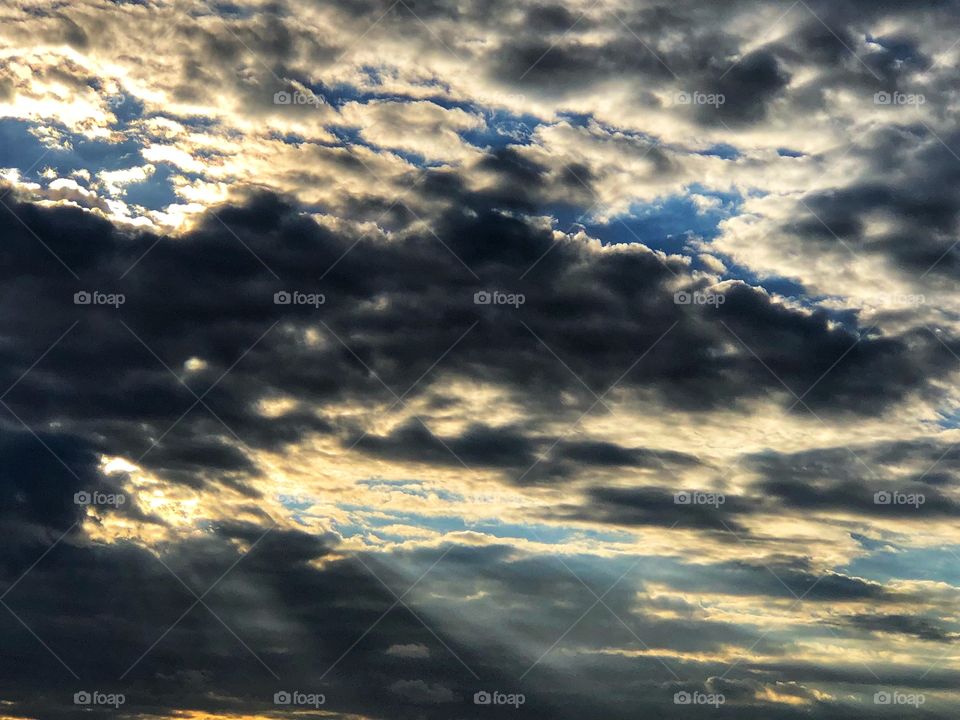 Breaking dawn full of clouds. Rays of sun light passing through the clouds... 