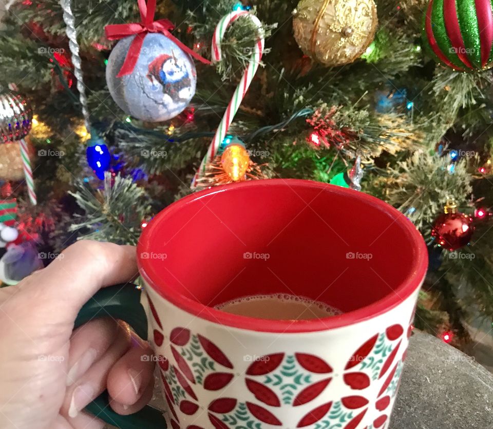 Hot cocoa in front of Christmas tree 