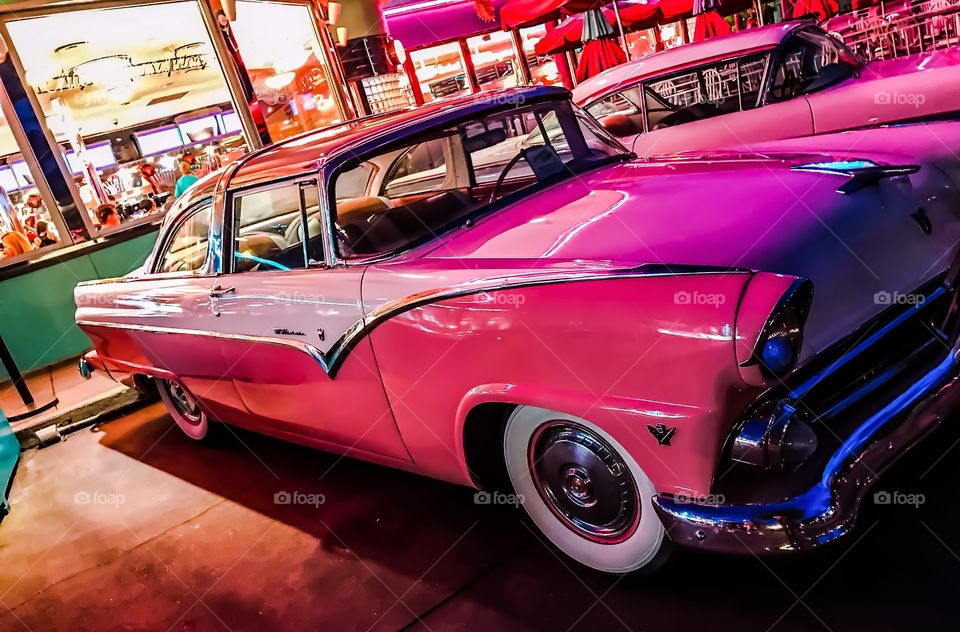 There is nothing like the shine of a classic automobile under the glow of neon.