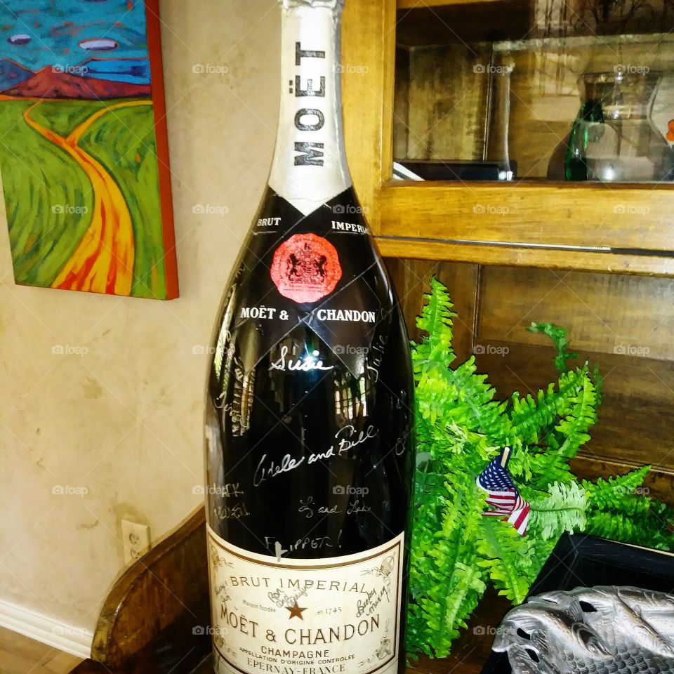This is a Texas size champagne bottle that is sitting in the living room at a house that I am painting