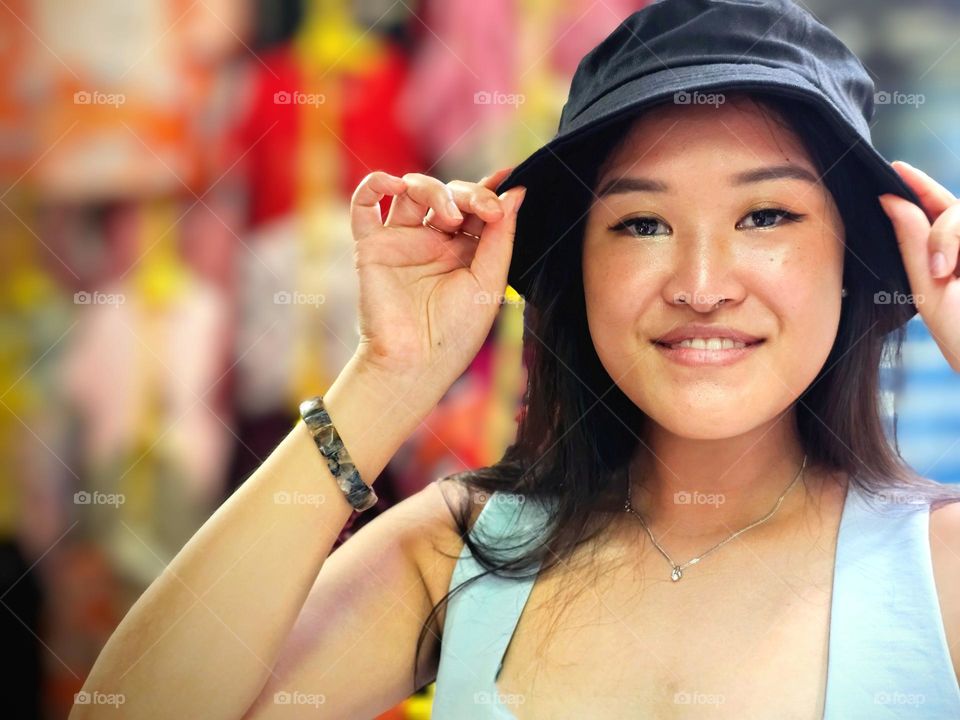 Lady happy shopping for a hat at the traditional street market