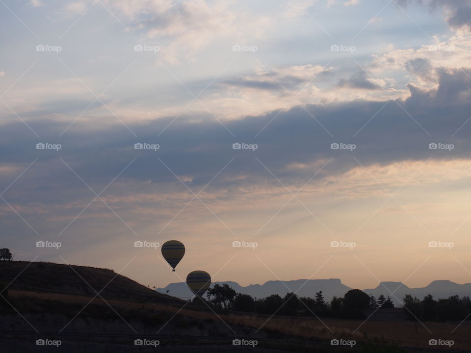 Hot air balloons flying at sunrise
