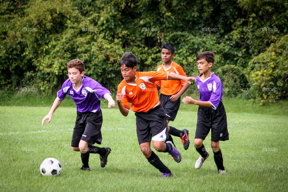 Teens are playing soccer