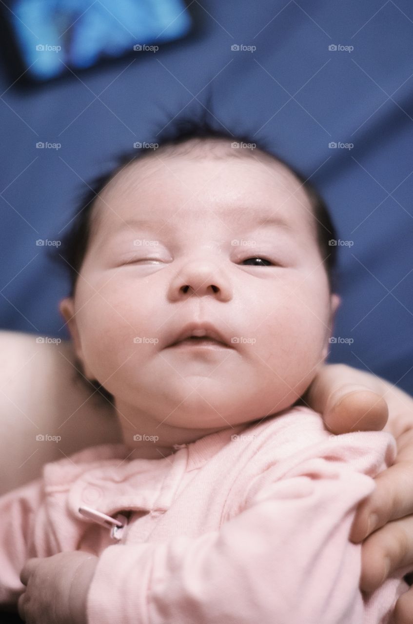 Close-up of person's hand carrying baby