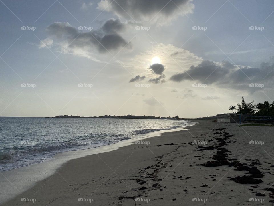 Sunset behind cloud at coastline 