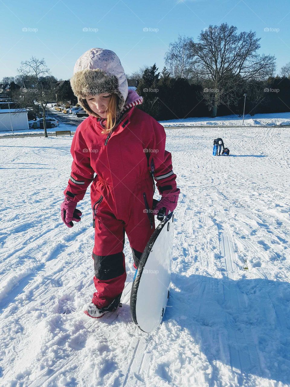 Girl going up a slope for a ride on the sledge