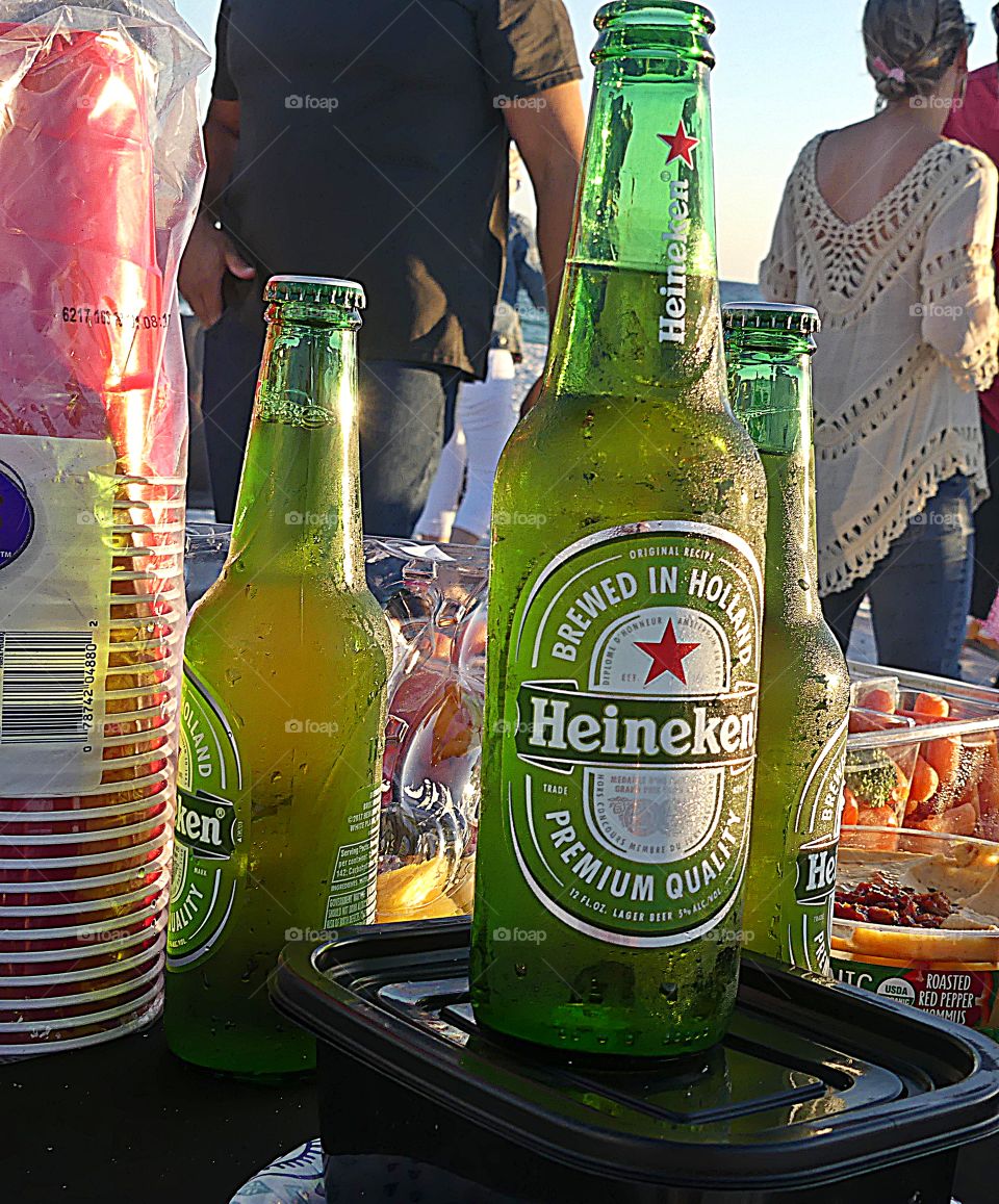 Genuine friends gathering on the beach in front of the Gulf of Mexico eating food and drinking ice cold Heineken. So much fun. 