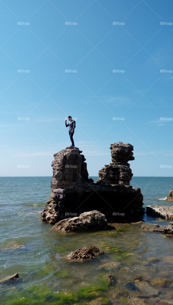 Man standing on a ruins in the sea