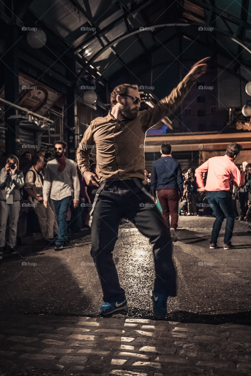 Street Dancing In The Night With Crowd Of People Watching
