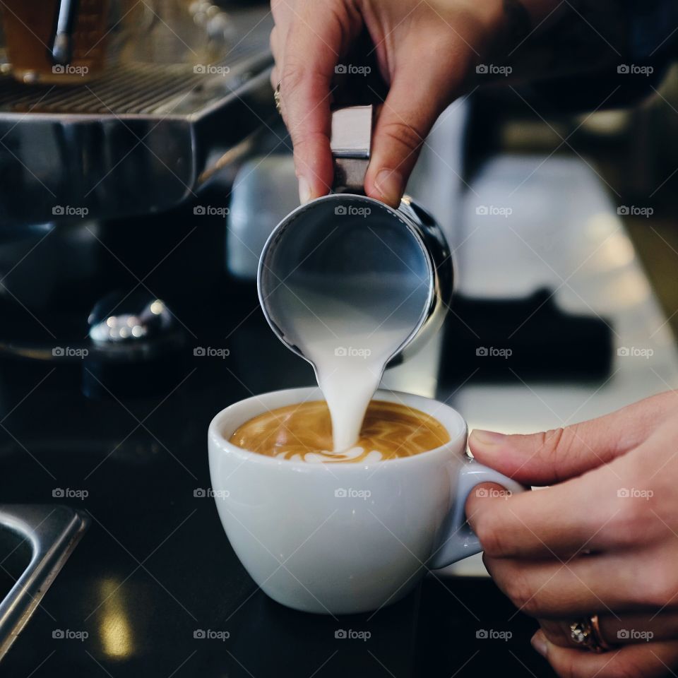 Barista making latte art coffee