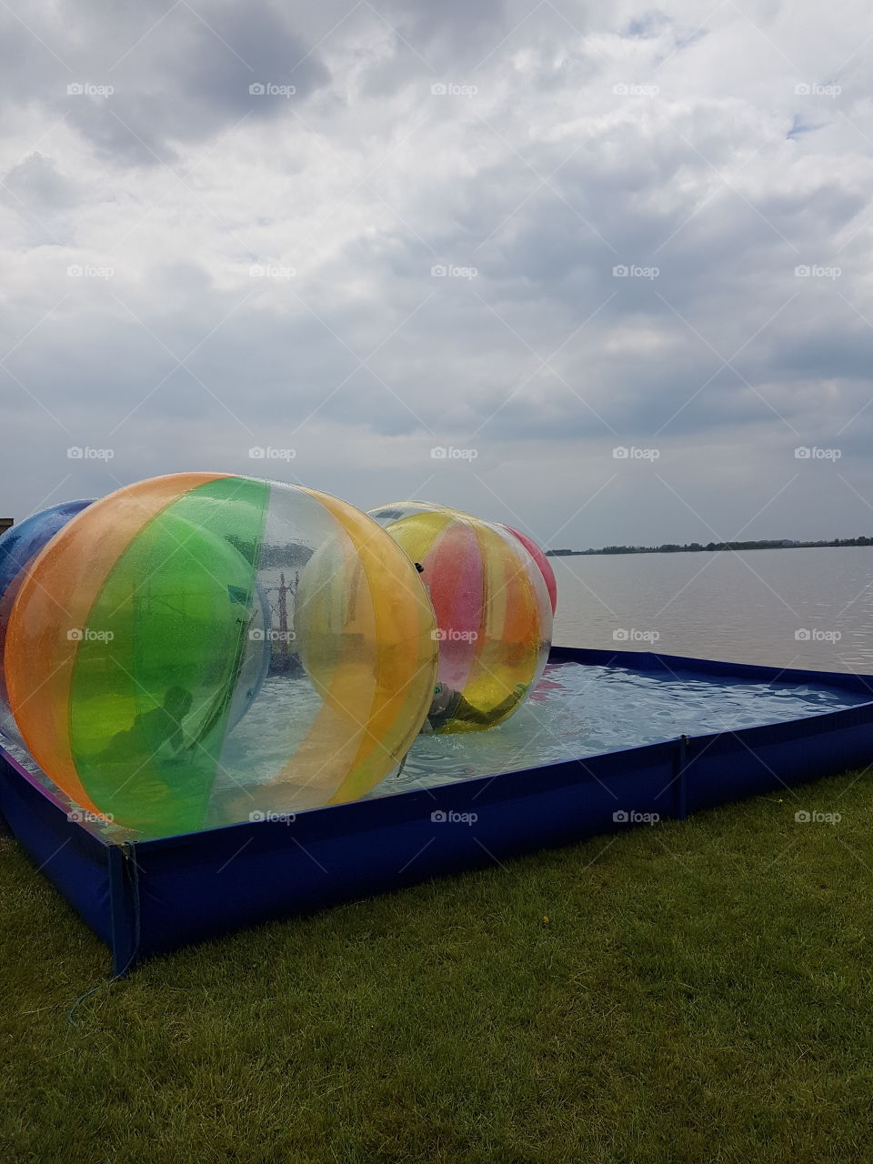 kids playground with balloons on the water besides lake