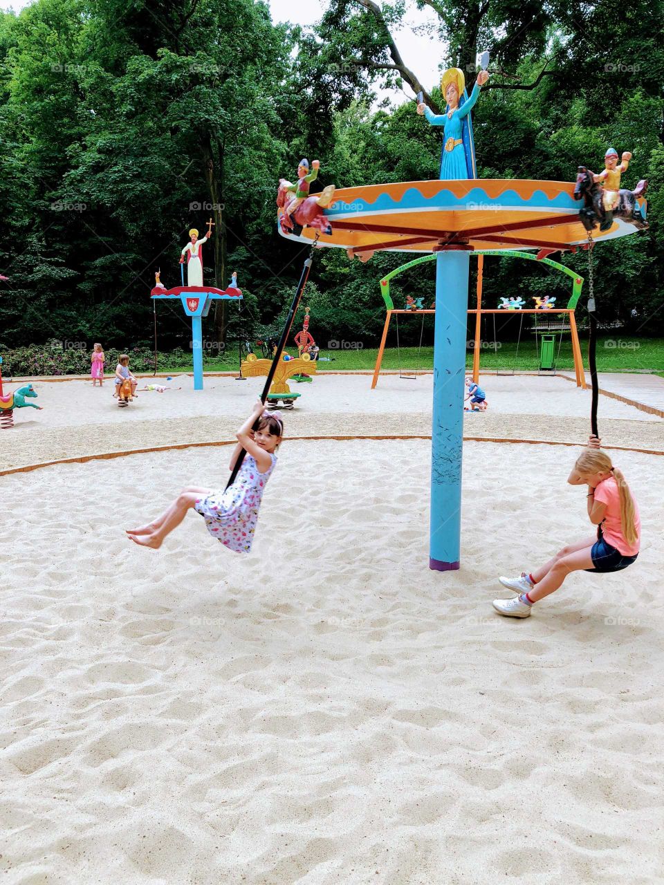 Girls playing on a swing