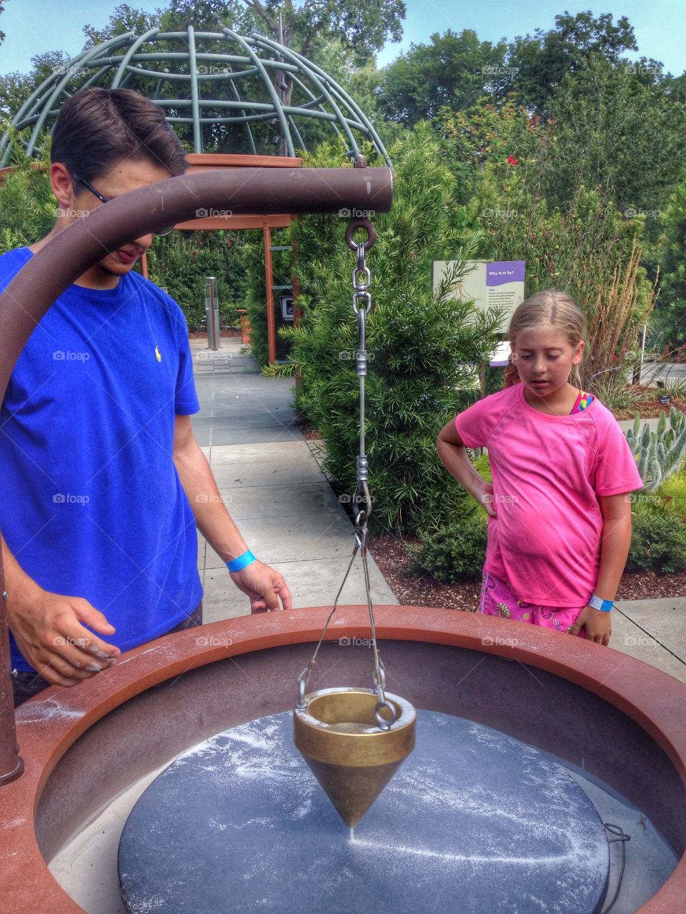 Sand art. Kids making sand art with a swinging funnel