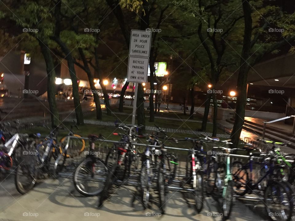 Bicycles lined up at a bike rack outside a New York City subway station entrance.