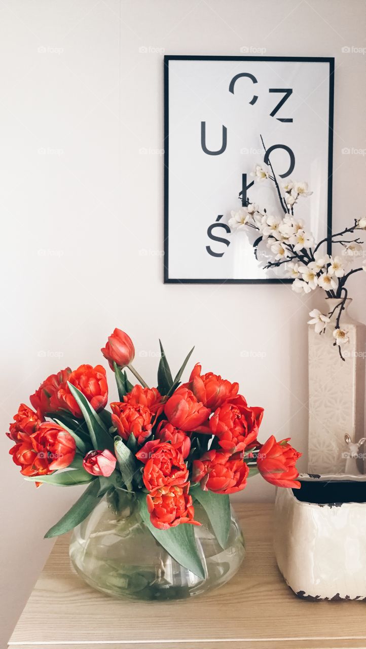 Glass vase with red tulips