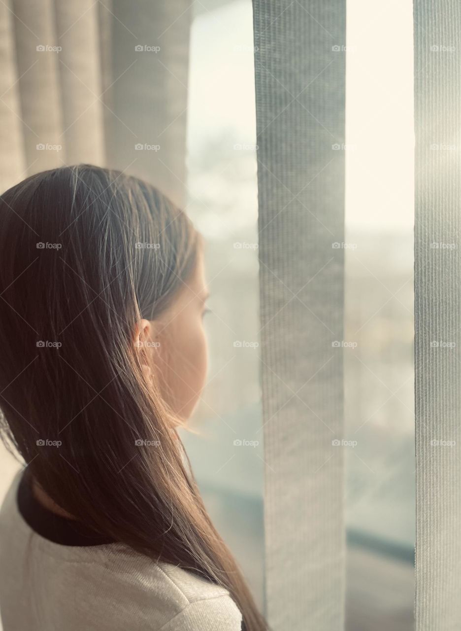 Girl, window and sunrise 