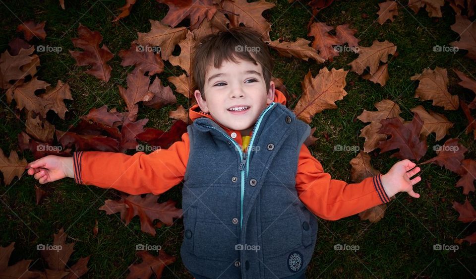 Boy in Autumn Leaves