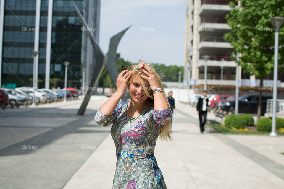 Happy woman standing on street