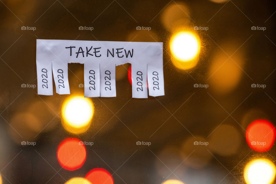 Christmas shop window with paper with the phrase: Take New and with a 2020 sign ready to be tore off