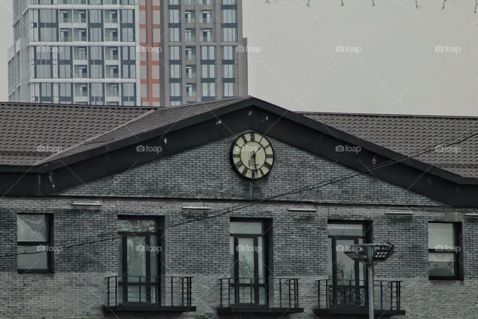 roof of a mansion with a clock on the roof