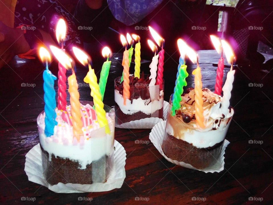 Three cupcakes with candles on top for birthday