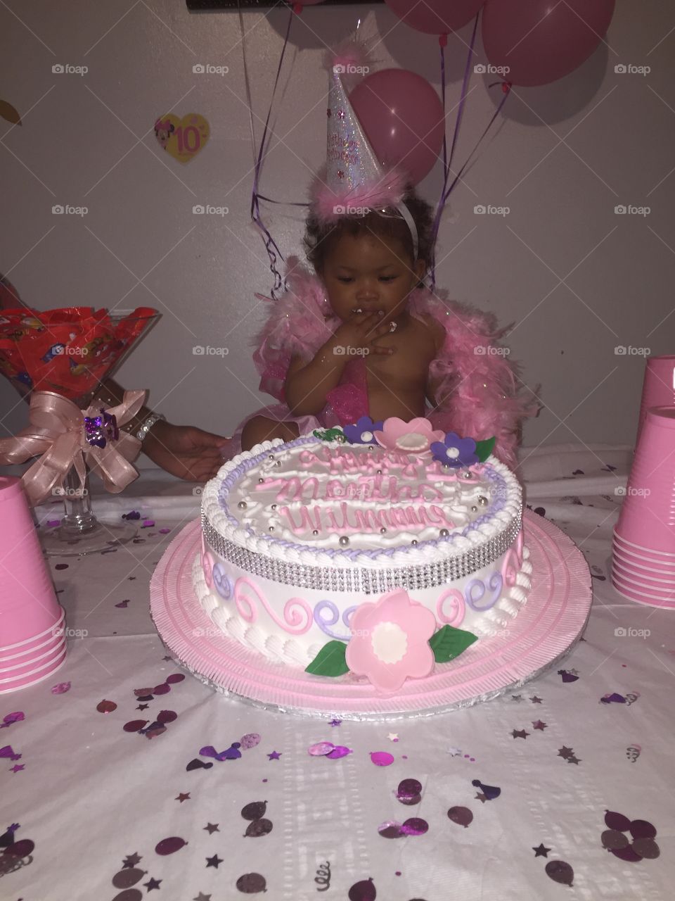 birthday girl enjoy her cake
 10 months party 
