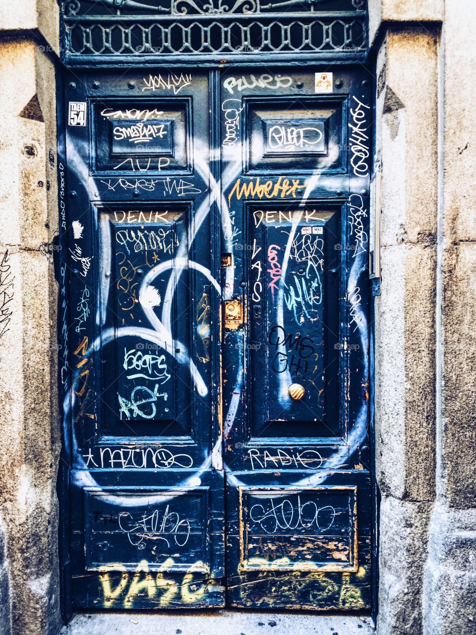 Wooden door with graffiti 
