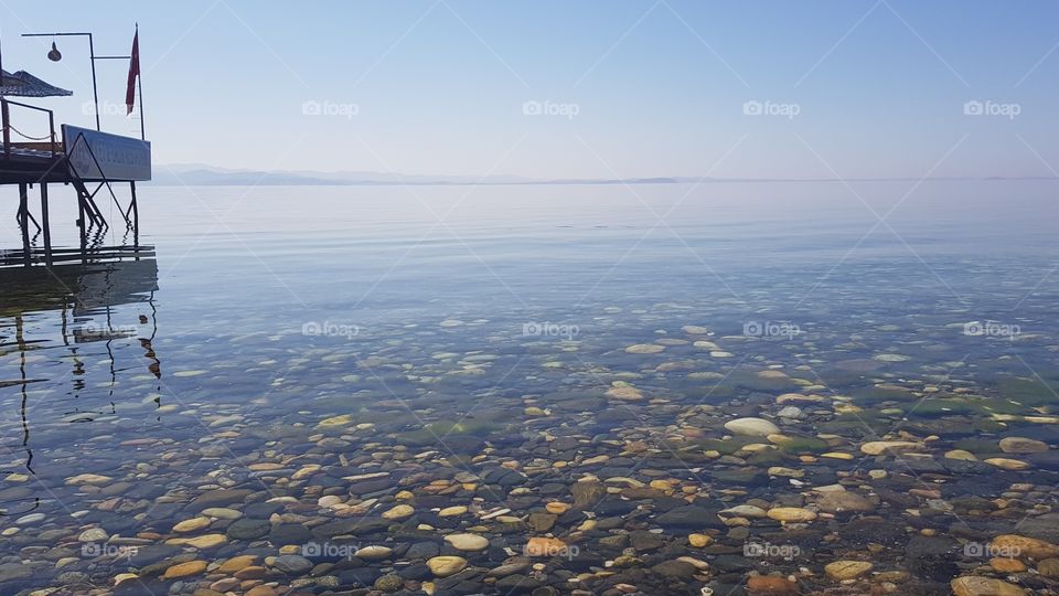 clear blue sea stones