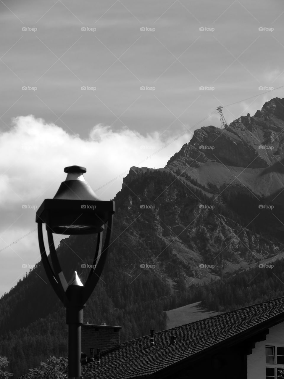 Black and white shot of mountain against sky in Ehrwald, Austria.