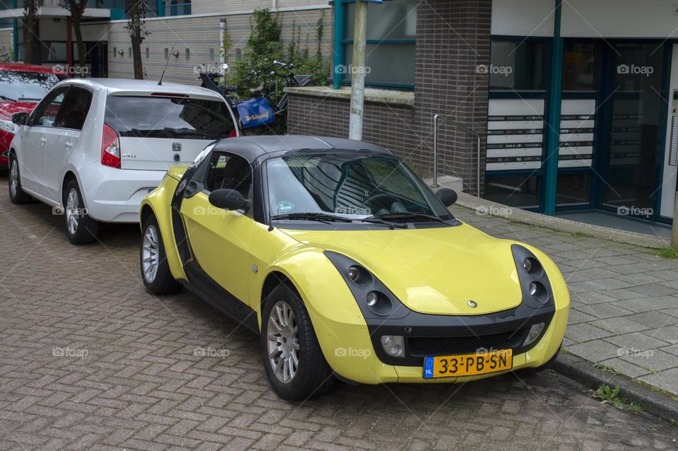 A Yellow Smart Car At Amsterdam The Netherlands 12-6-2024 (2)
