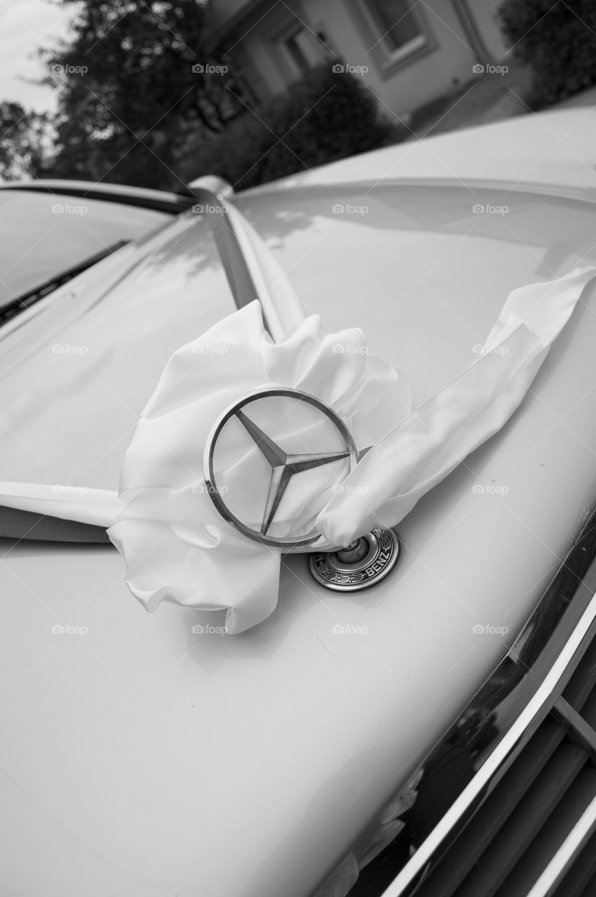 Wedding car decorated eith white ribbon