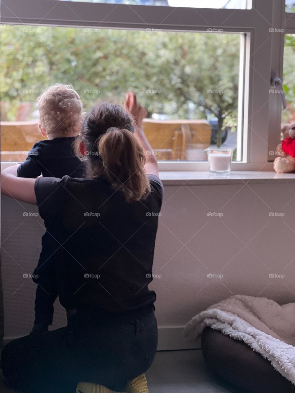 Teenager with her little best friend looking outside