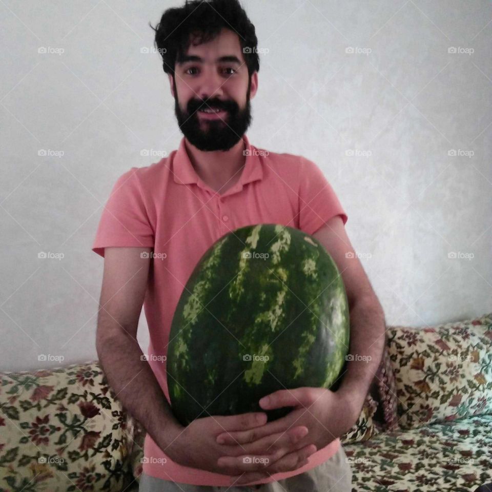 My eldest son holding a green melon