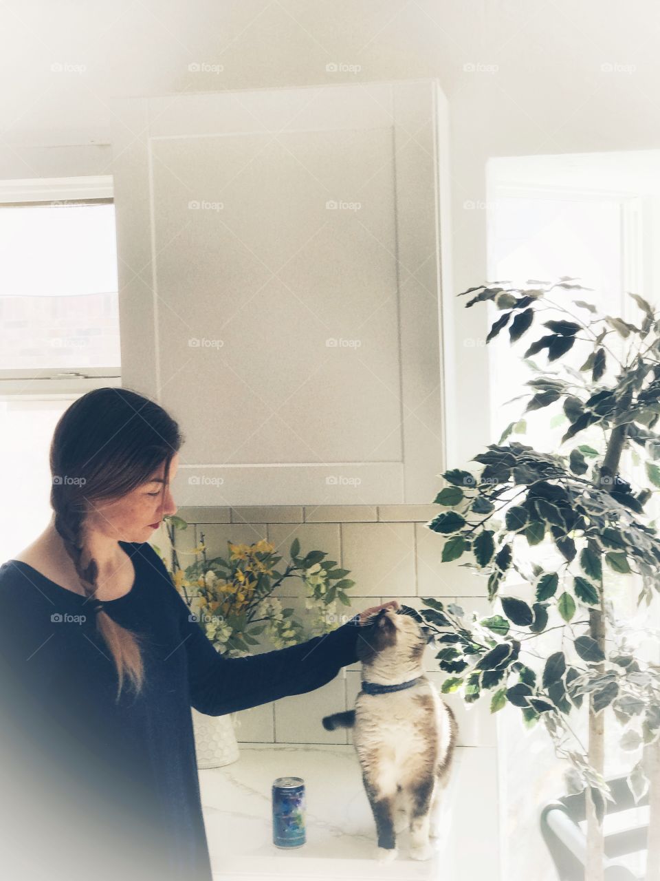 A joint woman playing with her sweet kitty.
